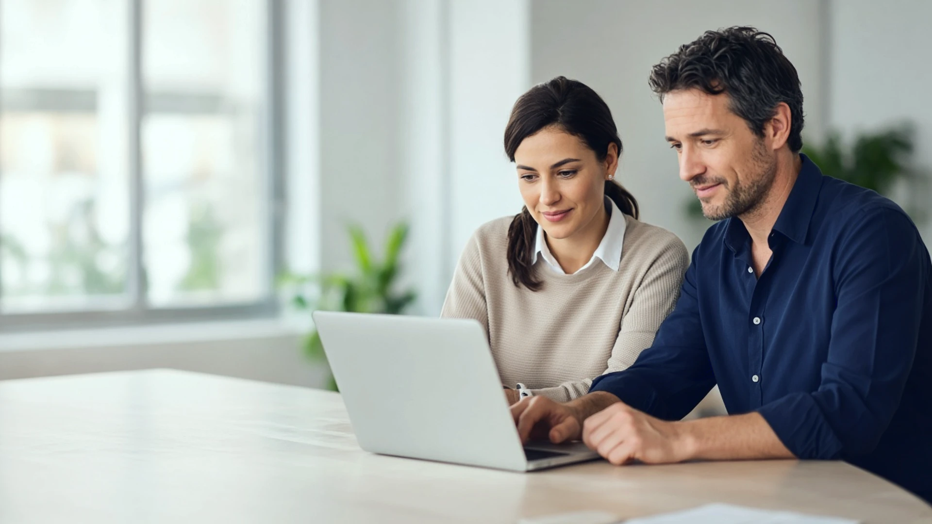 Two colleagues at a law firm reviewing a lead record on a laptop